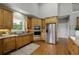 Kitchen features wooden cabinets, granite countertops and stainless steel appliances, creating a functional workspace at 2675 Portabella Ln, Cumming, GA 30041