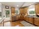 Bright kitchen featuring wooden cabinets, stainless steel appliances, and a door to the outdoor living area at 2675 Portabella Ln, Cumming, GA 30041