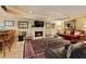 Cozy basement living area featuring a fireplace, bar, and ample seating for relaxation at 2675 Portabella Ln, Cumming, GA 30041