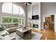 Bright living room with fireplace, large windows and comfortable seating, perfect for relaxation and entertaining at 2675 Portabella Ln, Cumming, GA 30041