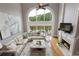 Bright living room featuring fireplace, large arched window, and comfortable seating with great views at 2675 Portabella Ln, Cumming, GA 30041