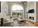 Inviting living room with a fireplace, large windows, high ceilings, and comfortable seating at 2675 Portabella Ln, Cumming, GA 30041