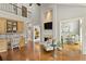 Spacious living space featuring a fireplace, built-in desk and view of an open floor plan at 2675 Portabella Ln, Cumming, GA 30041