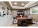 Well-lit home office with custom built-ins, coffered ceilings, and large desk area at 2675 Portabella Ln, Cumming, GA 30041