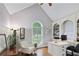 Bright home office with vaulted ceilings, built-in bookshelves, and a large arched window at 2675 Portabella Ln, Cumming, GA 30041