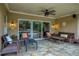 Covered patio featuring stone flooring, ceiling fan, and view of the backyard pool at 2675 Portabella Ln, Cumming, GA 30041