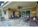 Inviting covered patio with stone flooring and comfortable seating, perfect for outdoor relaxation at 2675 Portabella Ln, Cumming, GA 30041