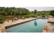 Inviting in-ground pool with stone patio, lake view, lounge chairs, and outdoor seating for relaxing and entertaining at 2675 Portabella Ln, Cumming, GA 30041