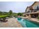Beautiful backyard with a sparkling pool, stone patio, and a view of the surrounding landscape at 2675 Portabella Ln, Cumming, GA 30041