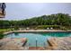 Stunning backyard pool with stone surround and lush greenery at 2675 Portabella Ln, Cumming, GA 30041