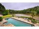 Breathtaking backyard oasis with a large pool overlooking a tranquil lake and lush landscaping at 2675 Portabella Ln, Cumming, GA 30041