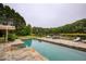 Refreshing in-ground pool with stone patio and beautiful lake view, perfect for outdoor leisure and recreation at 2675 Portabella Ln, Cumming, GA 30041