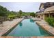 Backyard pool with stone patio, overlooking serene lake at 2675 Portabella Ln, Cumming, GA 30041