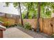 Outdoor space featuring a concrete patio, rock border, wooden fence and lush greenery at 151 Savannah Se St, Atlanta, GA 30316