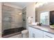 Modern bathroom with a glass-enclosed shower, gray tile, sleek fixtures, and a white vanity at 151 Savannah Se St, Atlanta, GA 30316