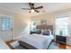 Bright bedroom featuring a ceiling fan, plush bedding, and natural light from two windows at 151 Savannah Se St, Atlanta, GA 30316