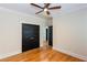 Bedroom with hardwood floors, white trim, and black paneled doors to closets at 151 Savannah Se St, Atlanta, GA 30316