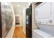 Hallway featuring a stackable washer and dryer, modern artwork, and a dark-stained sliding barn door at 151 Savannah Se St, Atlanta, GA 30316