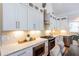 Bright kitchen featuring white cabinetry, stainless steel appliances, mosaic backsplash, and granite counters at 151 Savannah Se St, Atlanta, GA 30316