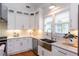 Stylish kitchen showcasing white cabinets, granite countertops, stainless steel appliances, and modern fixtures at 151 Savannah Se St, Atlanta, GA 30316