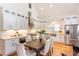 Modern kitchen with white cabinets, stainless steel appliances, granite countertops, and a wooden dining table at 151 Savannah Se St, Atlanta, GA 30316