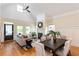 Bright living room featuring hardwood floors, neutral decor, a fireplace, and large windows at 151 Savannah Se St, Atlanta, GA 30316