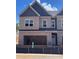 New construction townhome featuring brick exterior, attached garage, and modern architectural details at 3108 Marbella Cir # 4, Kennesaw, GA 30152
