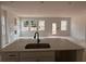 Spacious kitchen features a center island with sink and view of windows and back patio at 3108 Marbella Cir # 4, Kennesaw, GA 30152