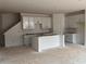 Open-concept kitchen showcasing a central island with a sink, ample cabinet space, and bright natural light at 3108 Marbella Cir # 4, Kennesaw, GA 30152