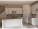 Modern kitchen featuring white cabinets, marble backsplash, and a center island with sink at 3108 Marbella Cir # 4, Kennesaw, GA 30152