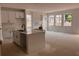Modern living room featuring recessed wall unit, large windows, and bright kitchen with island at 3108 Marbella Cir # 4, Kennesaw, GA 30152