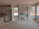 Living room featuring recessed wall unit, large windows, and bright kitchen at 3108 Marbella Cir # 4, Kennesaw, GA 30152