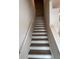Staircase with white risers and natural treads, leading to the upper level of the home at 3108 Marbella Cir # 4, Kennesaw, GA 30152