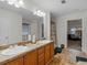 Bathroom featuring double sinks, a shower, and a view into the bedroom at 3430 Grand Manor Trl, Snellville, GA 30039