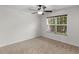 Cozy bedroom featuring a ceiling fan and large window with natural light at 3430 Grand Manor Trl, Snellville, GA 30039