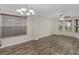 Bright living room with hardwood floors, natural light from windows, and elegant lighting fixture at 3430 Grand Manor Trl, Snellville, GA 30039