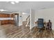 Open-concept living space with wood floors, stainless steel appliances, and stairs to upper level at 3430 Grand Manor Trl, Snellville, GA 30039