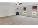 Carpeted living area features fireplace and windows with wood blinds at 3430 Grand Manor Trl, Snellville, GA 30039