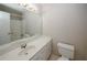 Bright bathroom with a single sink vanity and a large mirror reflecting the shower at 3697 E Bay St, Duluth, GA 30096