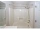 Neutral bathroom featuring a white bathtub and shower with chrome fixtures and a door at 3697 E Bay St, Duluth, GA 30096