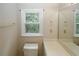 Bright bathroom featuring a white toilet, vanity, and a framed mirror at 3697 E Bay St, Duluth, GA 30096