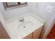 Neat half-bathroom featuring a vanity with brushed fixtures, a mirror, and a two-prong electrical outlet at 3697 E Bay St, Duluth, GA 30096