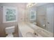 Well-lit bathroom features a large mirror, single sink, and window with a view at 3697 E Bay St, Duluth, GA 30096