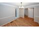 Charming dining room featuring wood floors, modern chandelier, and neutral paint, creating an inviting atmosphere for gatherings at 3697 E Bay St, Duluth, GA 30096