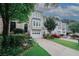 Beautiful townhome featuring a two-car garage, a driveway, and a beautifully landscaped front yard at 3697 E Bay St, Duluth, GA 30096