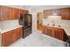 Functional kitchen featuring stainless steel refrigerator, sleek countertops, and wood cabinets, offering a practical cooking environment at 3697 E Bay St, Duluth, GA 30096