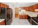 Kitchen featuring stainless steel appliances, wood cabinets, and open layout providing a seamless cooking and dining experience at 3697 E Bay St, Duluth, GA 30096