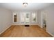 Bright living room with hardwood floors, double doors to backyard, and view of bath at 3697 E Bay St, Duluth, GA 30096