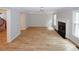 Bright living room features a fireplace, large windows, and stylish flooring at 3697 E Bay St, Duluth, GA 30096