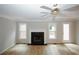 Inviting living room features a modern fireplace, ceiling fan, wood-look floors, and a glass panel door at 3697 E Bay St, Duluth, GA 30096